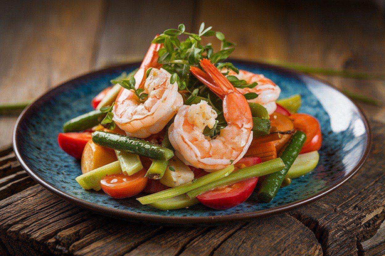 Sizzling shrimp stir fry with snap peas and julienned carrots in a glossy sauce