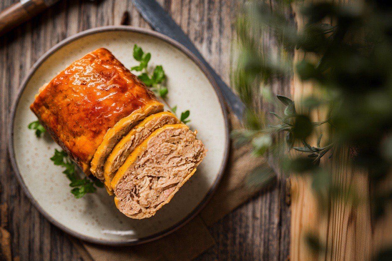 Sliced turkey meatloaf with ketchup glaze on a cutting board showing moist interior